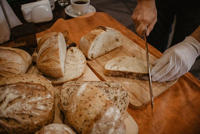 Close-up of hand holding bread on table