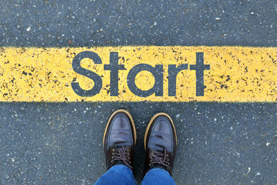 Low section of person standing on road