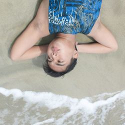 High angle portrait of cute boy on bed