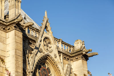 Low angle view of notre-dame against blue sky
