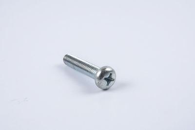 Close-up of screw on gray background