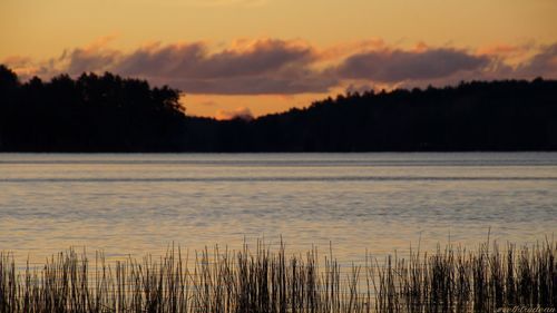 Scenic view of lake against sky during sunset