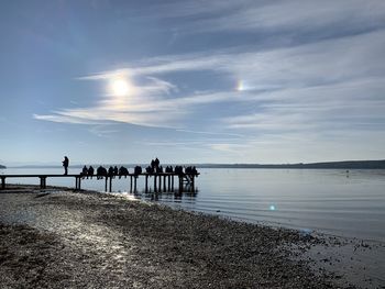 People on beach against sky