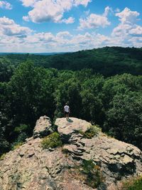 Man on rock against sky