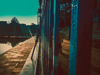 Bridge over river against buildings in city