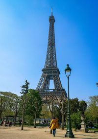 Rear view of woman standing against eiffel tower