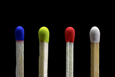 Close-up of multi colored pencils against black background