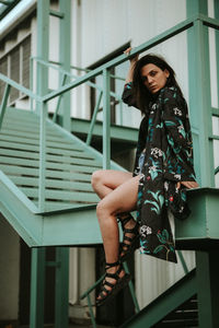 Young woman sitting on staircase