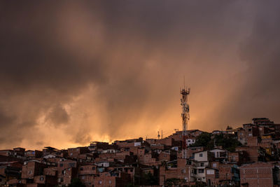 Buildings in city against sky during sunset