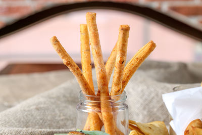 Close-up of french fries in jar