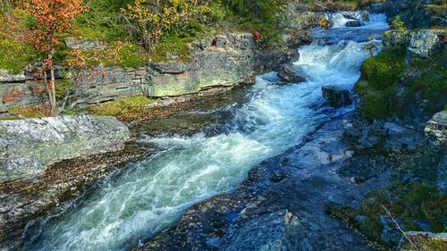 Scenic view of stream flowing through rocks