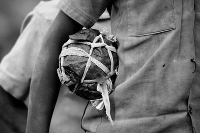 Midsection of man carrying bag 