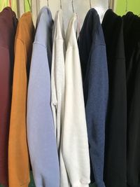 Midsection of clothes hanging on rack in store