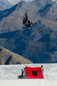 Person with umbrella on snowcapped mountain