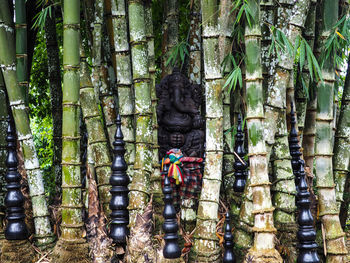 Statue amidst trees against plants