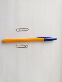 High angle view of colored pencils against white background