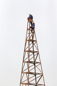 Low angle view of communications tower against sky