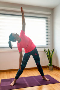 Full length of man skateboarding at home