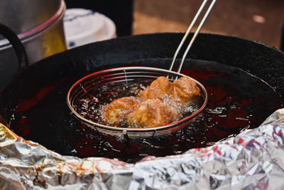 High angle view of frying momos in oil