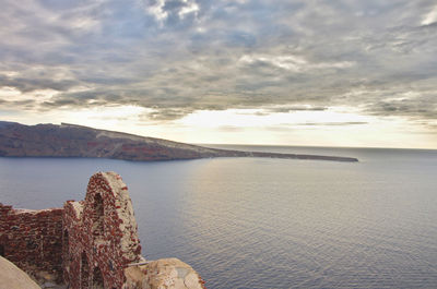 Scenic view of sea against cloudy sky