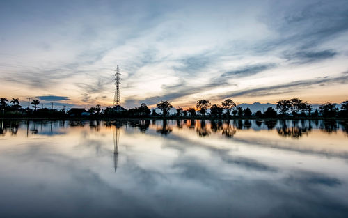 Scenic view of lake against sky during sunset