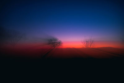 Scenic view of silhouette landscape against sky at sunset