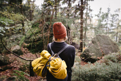 Rear view of man standing in forest