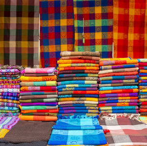 Stack of multi colored textile for sale at market stall