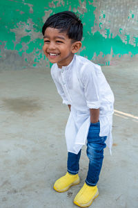 Portrait of smiling boy standing outdoors