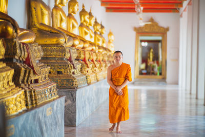 Full length of a buddha statue in temple