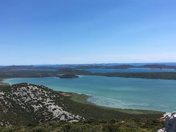 Scenic view of sea against clear blue sky