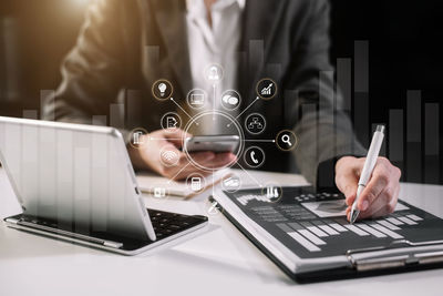 Midsection of man using laptop on table