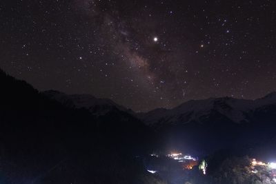 Scenic view of mountains against sky at night