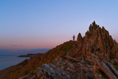 Rock formations against sky at sunset