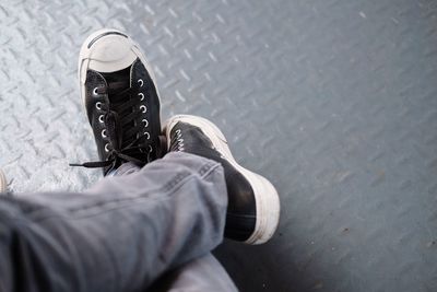 Low section of person standing on metal