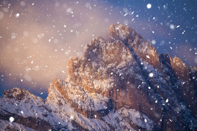 Low angle view of snowcapped mountain against sky