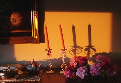 Close-up of illuminated lamp on table at home