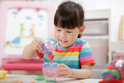 Young girl making sands craft at home 
