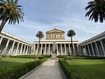 View of temple by building against sky
