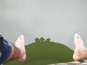 Low section of man legs against water