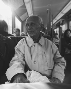 Rear view of man sitting on corridor