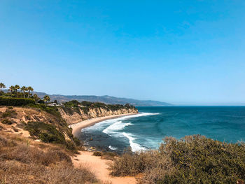 Scenic view of sea against clear blue sky