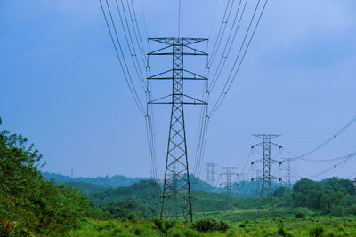 High voltage power tower industrial landscape at sunrise,urban power transmission lines.