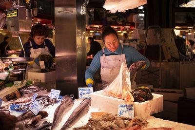 People standing in market stall