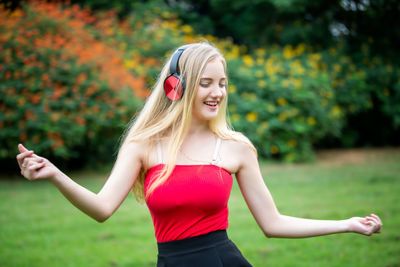 Young woman smiling while sitting in park