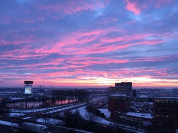 City against cloudy sky during sunset