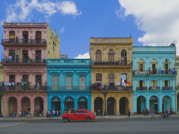 View of buildings in city against blue sky