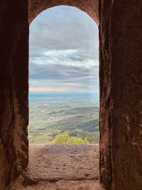 Scenic view of mountains against sky seen through window