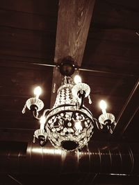 Low angle view of illuminated lamp hanging on ceiling