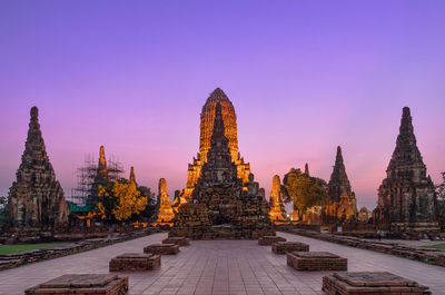 Old ruin of wat chaiwatthanaram temple against clear sky during sunset